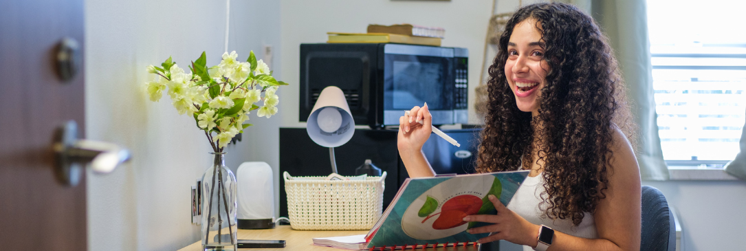 girl at desk in dorm room