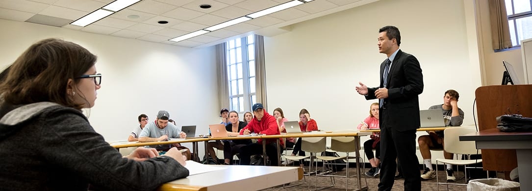 Finance class showing professor in the center of the room teaching